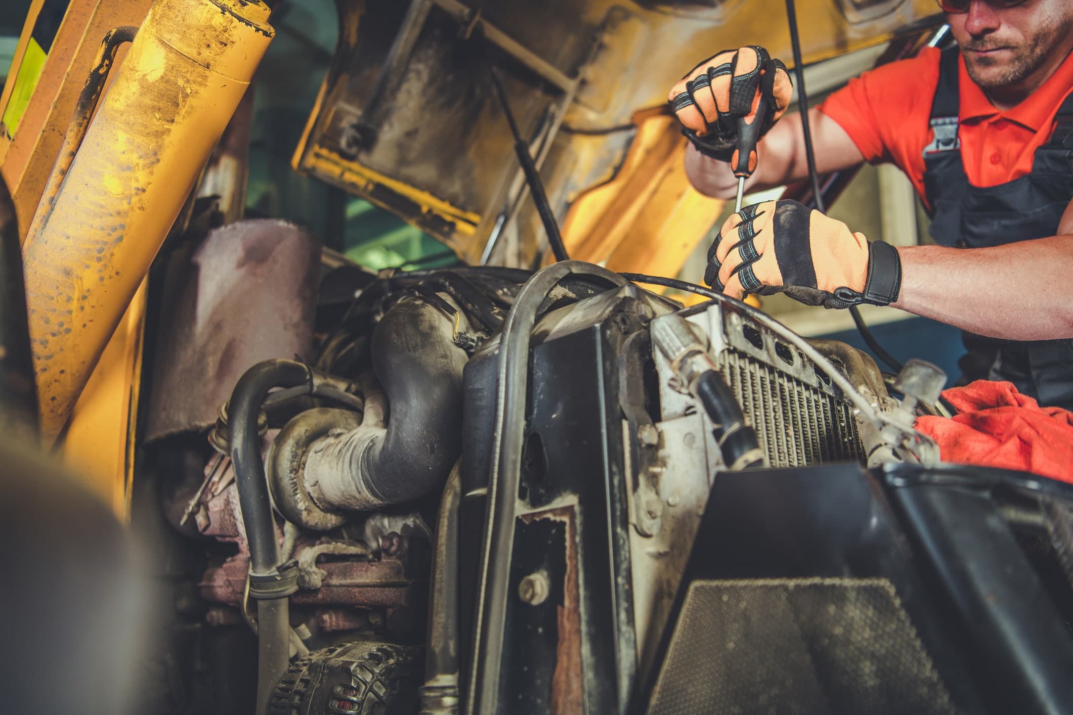 Forklift handling freight inside a heavy duty equipment repair facility
