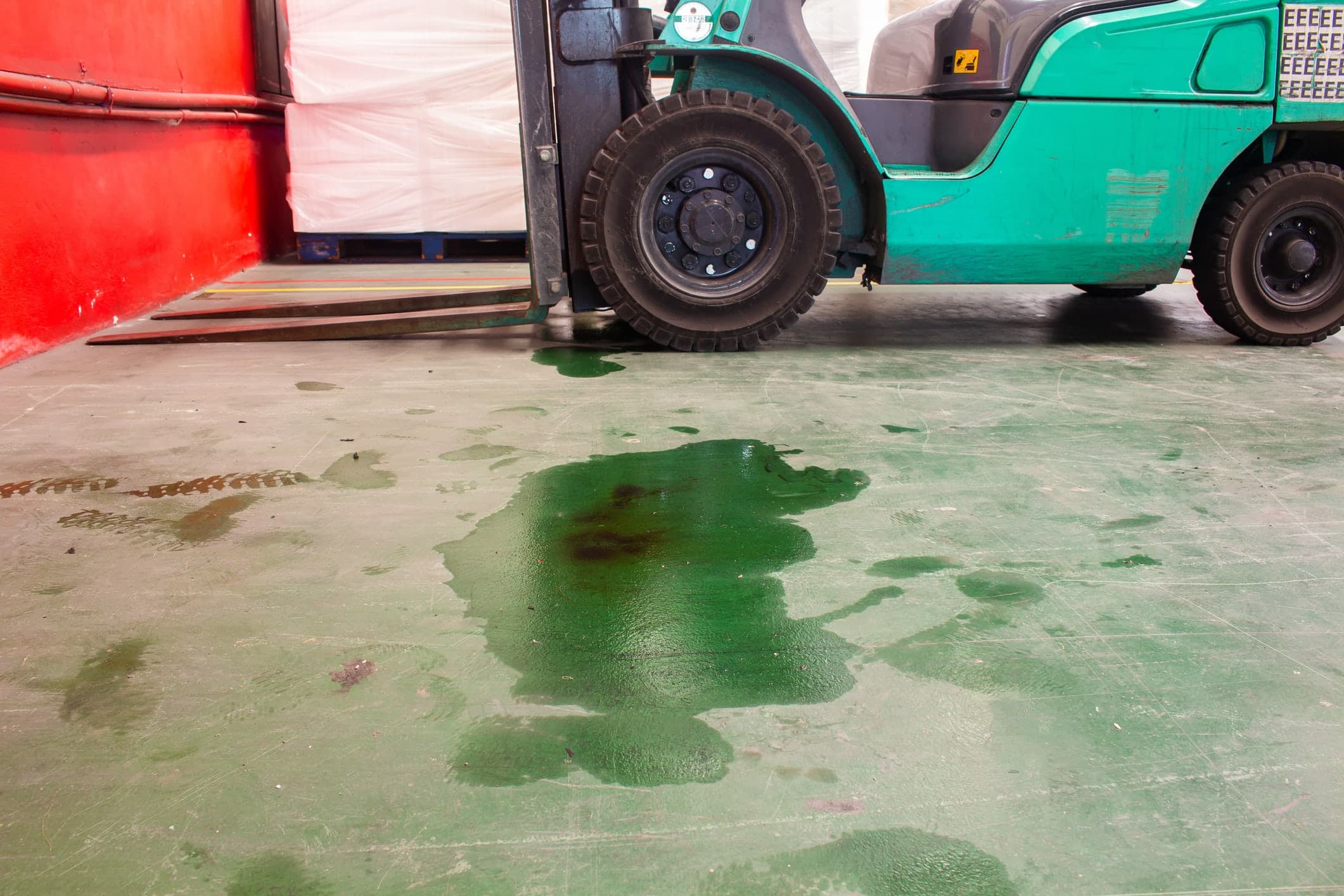 Forklift handling freight inside a heavy duty equipment repair facility