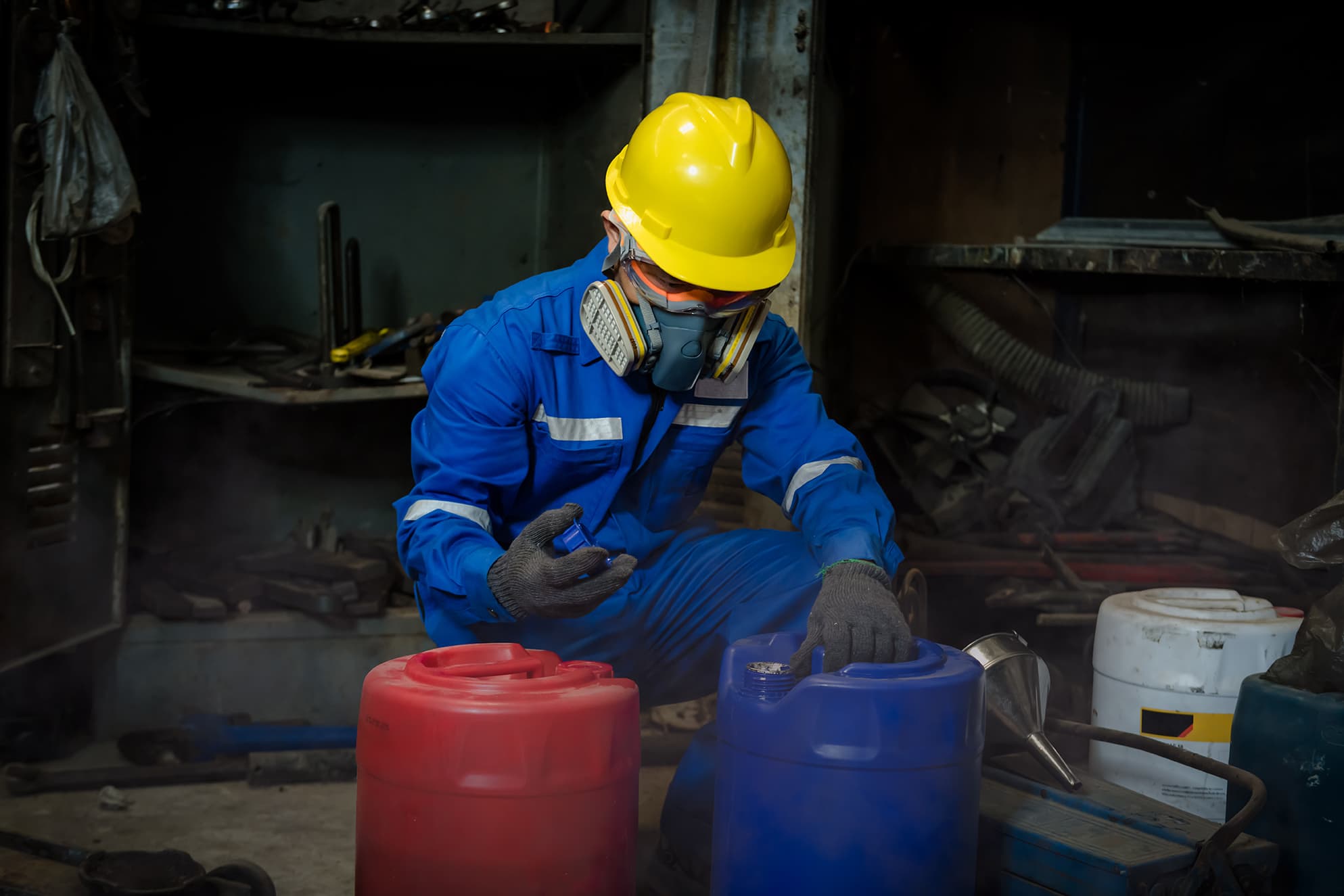 Environmental compliance specialist handling hazardous material drums