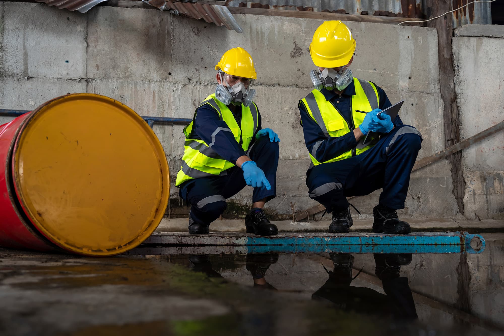 Workers in PPE at an industrial site