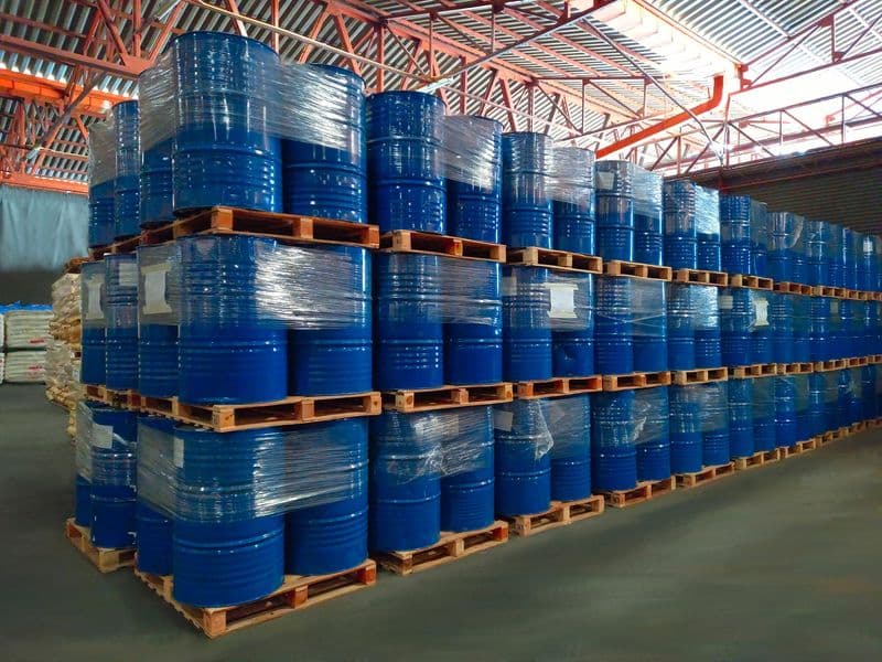 Array of vibrant paint cans, showcasing GMG EnviroSafe's dedication to EHS compliance for paint distributors