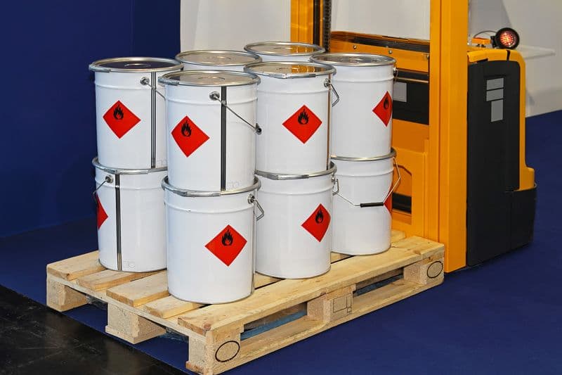 Array of vibrant paint cans, showcasing GMG EnviroSafe's dedication to EHS compliance for paint distributors